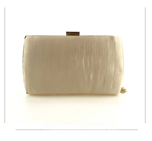 Back view of light gold satin evening clutch featuring pleated texture and long gold tassels