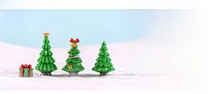 Detailed view of assorted miniature resin Christmas trees with festive star and bow ornaments