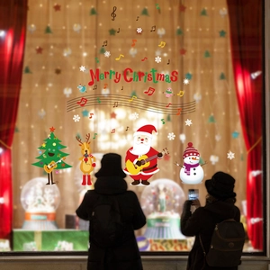 Festive Merry Christmas window stickers featuring Santa, reindeer, and music notes on glass
