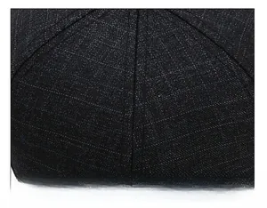 Detailed close-up of navy blue baseball cap top crown with reinforced stitching