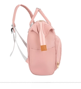 Side view of pink nylon mommy backpack showing wide shoulder straps and side pockets