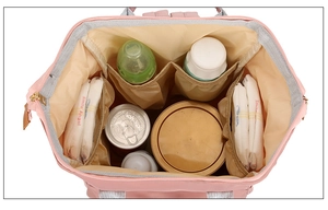 Detail view of pink nylon mommy bag with organized interior compartments for baby supplies
