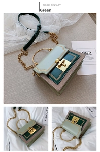 Detail of color-block green handbag with gold circular metal handle and twist lock