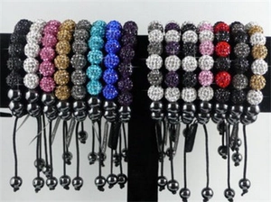 Detailed display of colorful Shamballa clay beads with crystal pave on adjustable bracelets