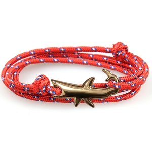Shark anchor bracelet with red white and blue braided rope and golden metal clasp