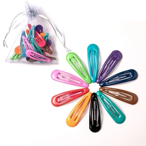 Detail showing colorful candy-colored metal hair clips arranged in a creative flower shape