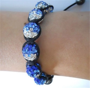 Close-up of blue crystal Shamballa bead bracelet with adjustable black braided cord on wrist