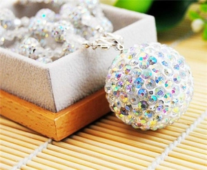 Macro shot of 8mm AB crystal paved clay disco ball pendant on a silver metal chain necklace