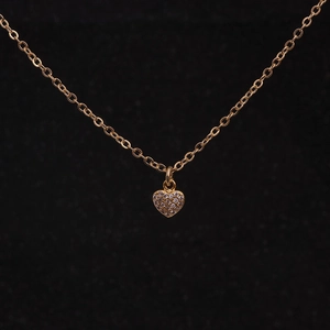 Close-up of golden heart pendant necklace featuring sparkling micro-pave cubic zirconia