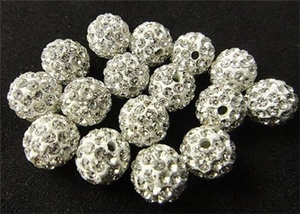 Macro shot of 7x12mm white rhinestone encrusted clay beads for DIY jewelry making
