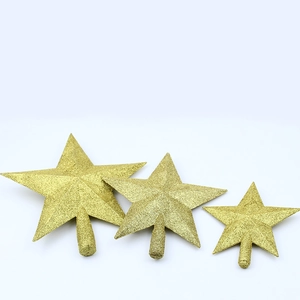 Three gold glittered five-pointed star tree toppers with stems for holiday decorations