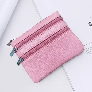 Macro detail of pink litchi grain leather wallet with three-layer silver zippers