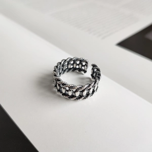 Macro detail of S925 sterling silver stamp on vintage double-layer woven olive ring