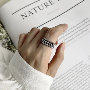 Retro 925 sterling silver olive ring with braided texture worn on index finger