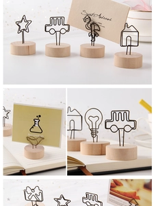 Detail of wooden card holders with creative star and animal shaped metal wire clips