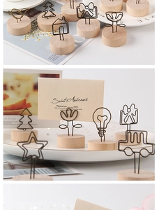 Close-up of wooden memo holders in various shapes like bird and tree for home decor