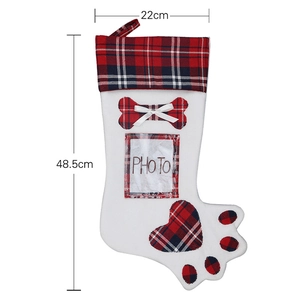 Dog paw Christmas stocking with red plaid accents and photo pocket for tree decor