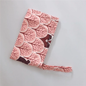 Detail of coral pink cotton phone bag with brown bear print and portable wrist strap
