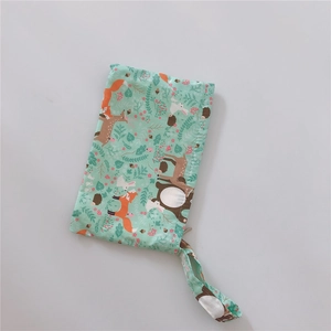 Detail of fabric phone pouch with green forest animal patterns and matching wrist strap