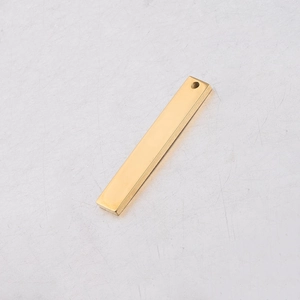 Polished gold stainless steel rectangular bar pendant with small hole on grey surface