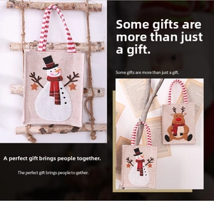 Detail of Christmas burlap gift bags with snowman and elk embroidery and striped handles