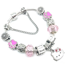Close-up of pink unicorn bracelet featuring cat paw beads and hello kitty charm