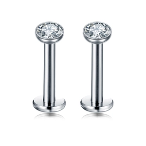 Macro shot of polished stainless steel labret stud with sparkling zircon and flat back disk