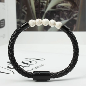 Detail of men's braided leather bracelet with marble beads and black magnetic clasp