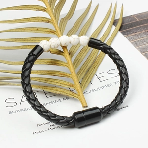 Detail of men's braided leather bracelet with marble beads and magnetic clasp