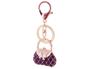 Detail of purple enamel handbag keychain with bow and rhinestones on rose gold hardware