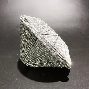 Detailed side view of 3D diamond shaped silver evening bag fully encrusted with crystals