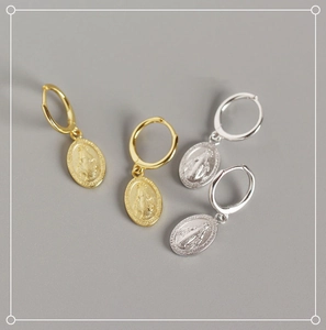 Detail of S925 sterling silver Virgin Mary coin earrings in gold and silver finish
