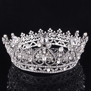 Detailed view of silver Baroque bridal crown featuring intricate rhinestone inlay on dark surface