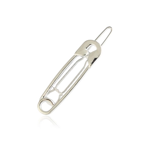 Detail of a minimalist silver metal safety pin hair clip with a polished finish and reflection