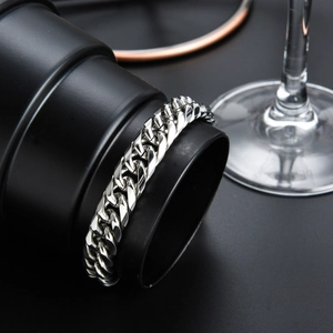 Close-up of polished 316L stainless steel Cuban link bracelet on a display stand