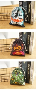 Three assorted Halloween drawstring gift bags with pumpkin and skull prints on a wooden table