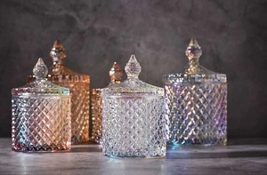 Detail of colorful iridescent glass jars with diamond patterns and pointed lids