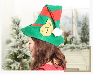 Detail of red and green striped elf hat with ears and a white pompom for Christmas decor