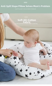 Close-up of cotton nursing pillow with black star pattern used as a baby support seat