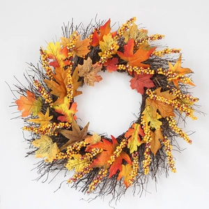 Autumn wreath with maple leaves, sunflowers, and berries on a rustic twig base