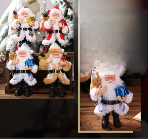 Detail view of plush resin Santa ornaments with golden hanging strings and multiple colors