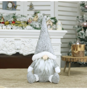 Dettaglio di uno gnomo di Natale grigio con barba bianca e cappello in feltro festivo