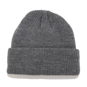 Detail view of dark grey knitted beanie showing thick ribbed texture and folded brim