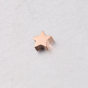 Close-up of a polished rose gold stainless steel star-shaped pendant charm for DIY jewelry
