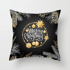 Détail de la housse de coussin de Noël noire avec étoiles dorées et lettrage blanc