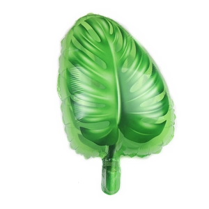 Macro shot of green monstera leaf foil balloon with metallic finish on white background
