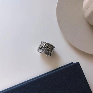 Macro detail of retro 925 sterling silver wide wing ring with antique carved texture