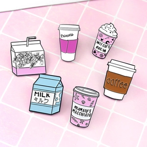 Detailed view of pastel enamel pin set featuring cute milk boxes and coffee cups on pink grid