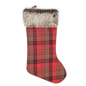Classic red plaid Christmas stocking with white faux fur trim on a clean white background