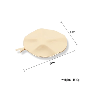 Detail view of gold geometric irregular hair clip showing 5cm by 6cm dimensions and 15.5g weight